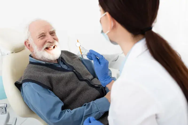 Dentist with senior patient for exam